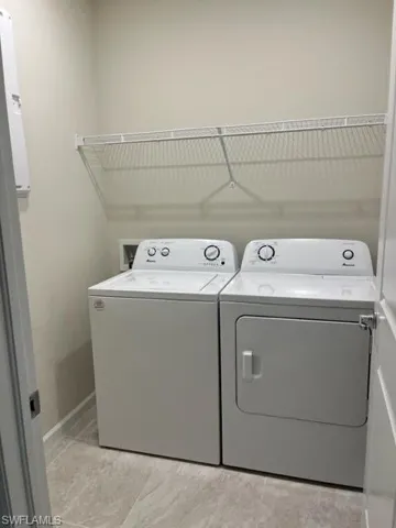 Laundry room with independent washer and dryer and laundry area