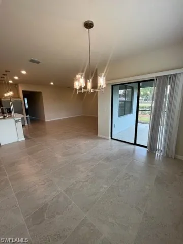 Spare room with an inviting chandelier, recessed lighting, baseboards, and visible vents