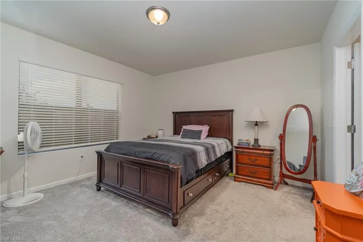 Bedroom featuring light carpet