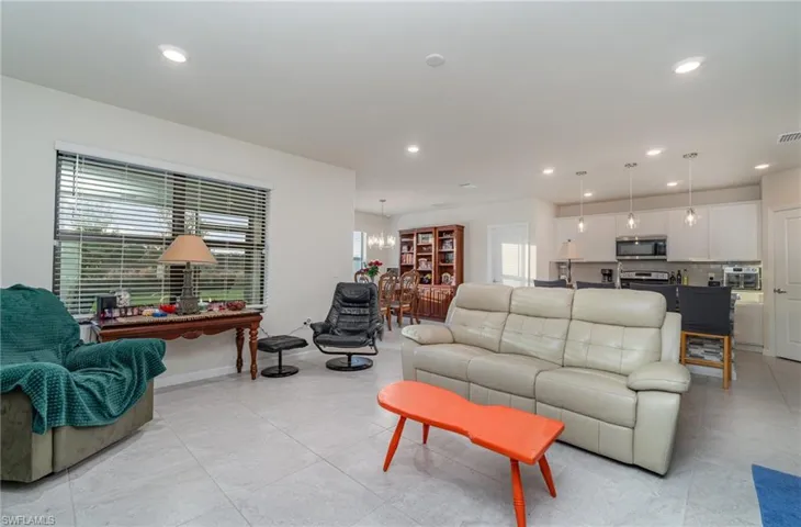 Living room with a wealth of natural light and an inviting chandelier