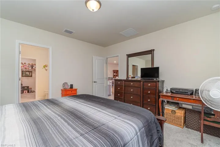 Carpeted bedroom with ensuite bathroom