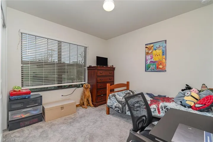 Bedroom featuring light colored carpet