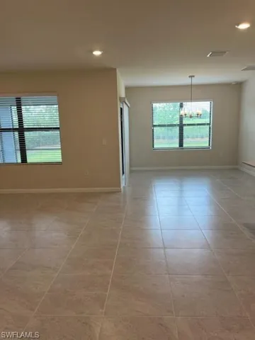 Unfurnished room with light tile patterned flooring, a chandelier, baseboards, visible vents, and recessed lighting