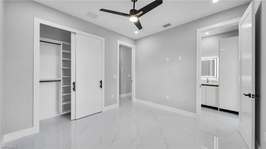 Unfurnished bedroom with light marble finish flooring, recessed lighting, a closet, and ceiling fan
