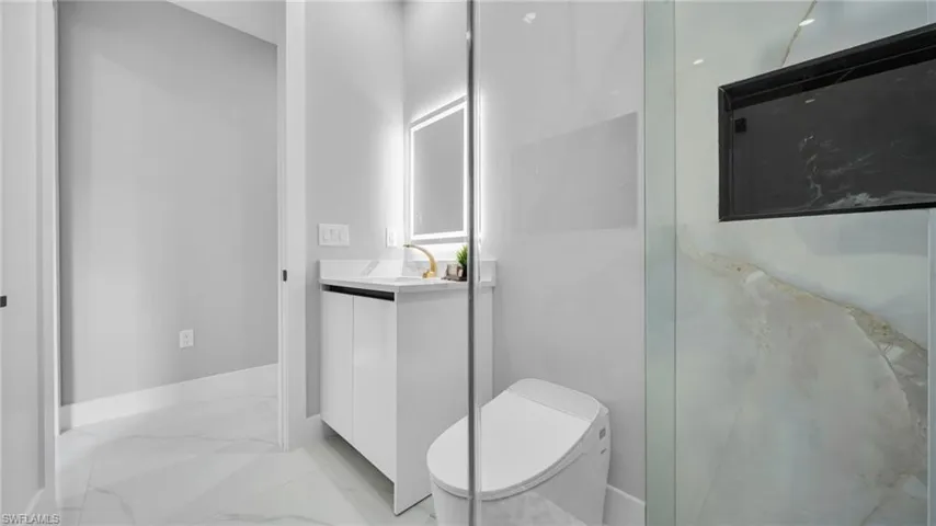 Bathroom featuring vanity and light marble finish floors