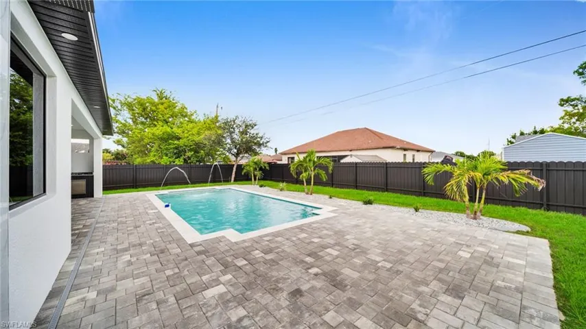 View of swimming pool with a fenced backyard and a patio area