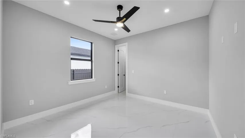 Unfurnished room with light marble finish floors, recessed lighting, and ceiling fan
