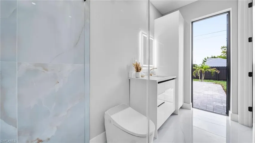 Bathroom with vanity and light marble finish flooring