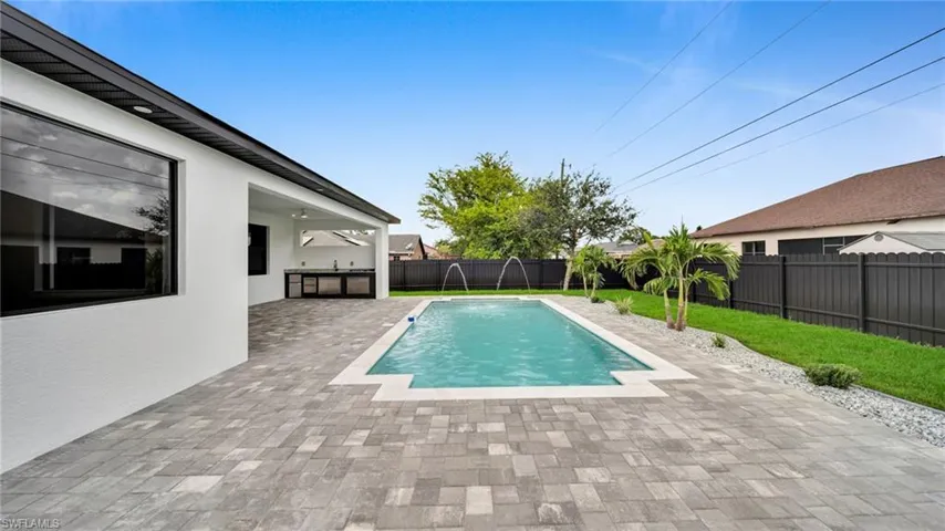 View of pool with a fenced backyard and a patio