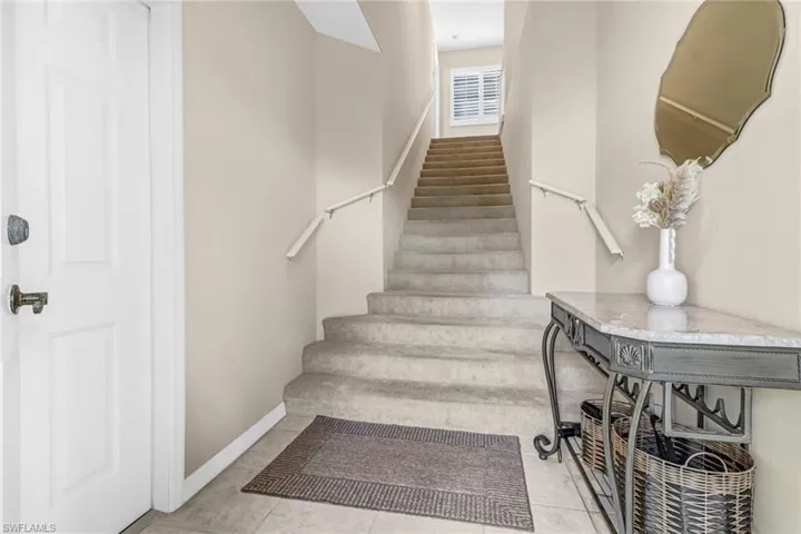 Stairs featuring tile patterned floors