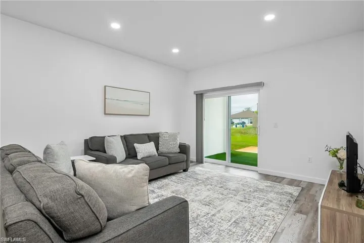Living room with recessed lighting and wood finished floors