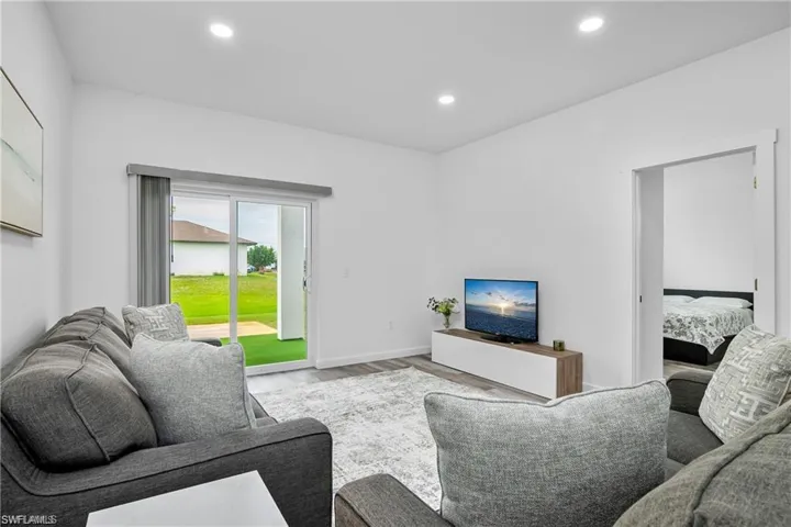 Living area with recessed lighting and wood finished floors