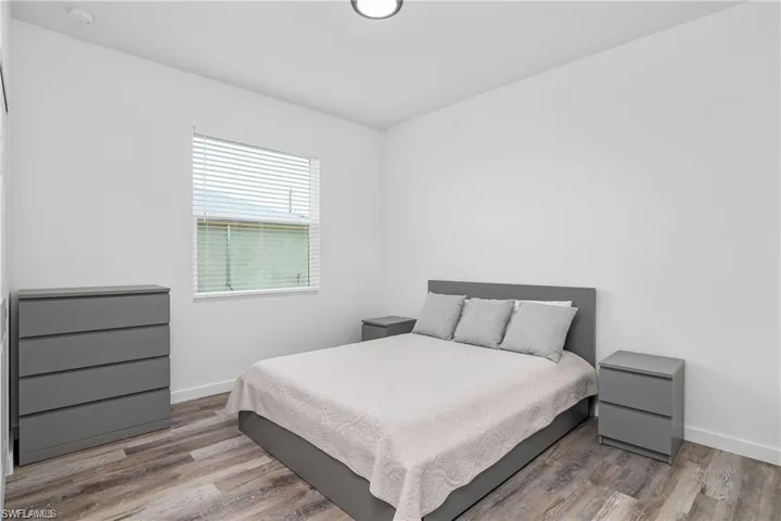 Bedroom featuring light wood-type flooring and baseboards