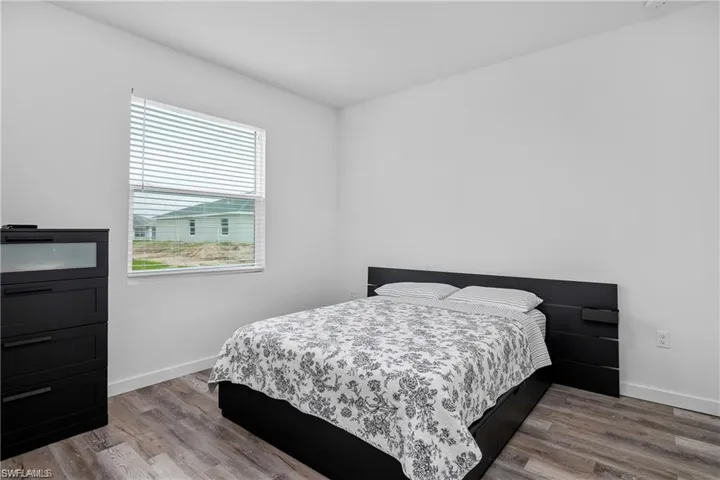 Bedroom featuring light wood finished floors and baseboards