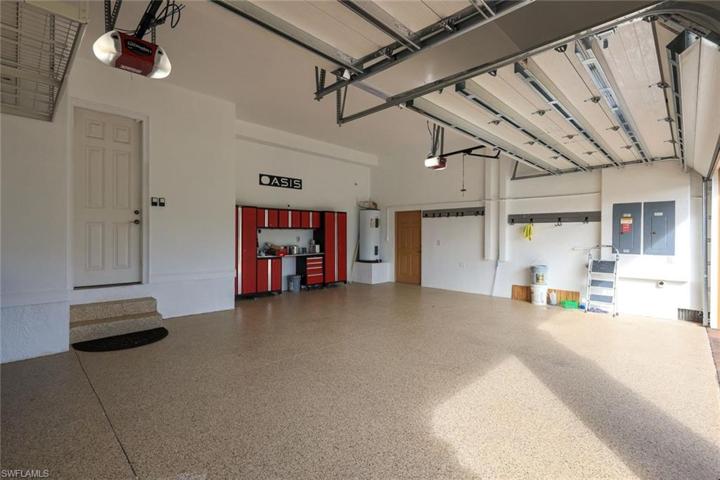3 CAR GARAGE WITH NEW EPOXY FLOOR AND CABINETS