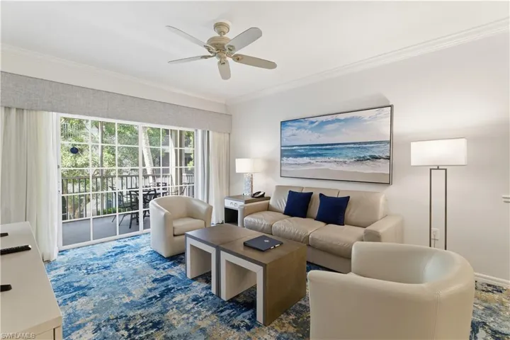 Living room with ornamental molding and ceiling fan