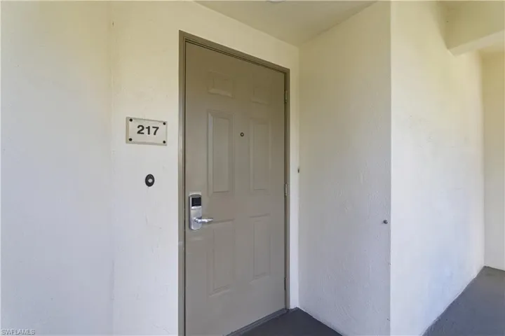Property entrance featuring stucco siding