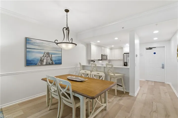 Dining space featuring recessed lighting, light wood finished floors, and crown molding