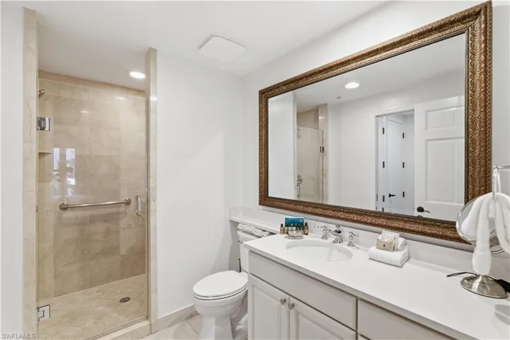 Full bathroom featuring vanity, a shower stall, and recessed lighting