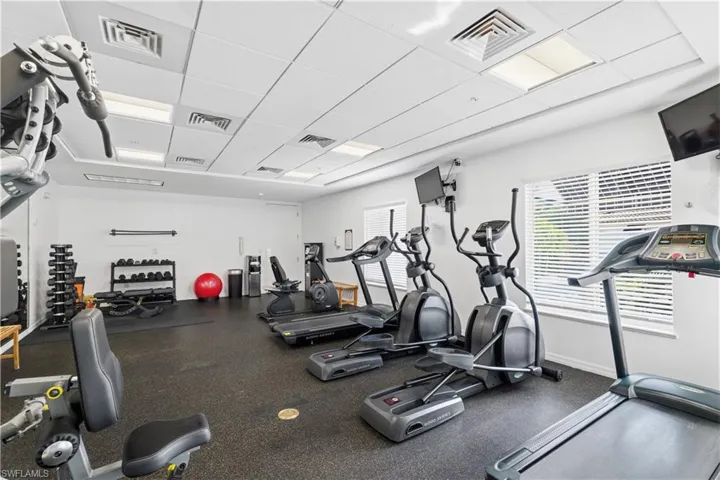 Workout area featuring a drop ceiling
