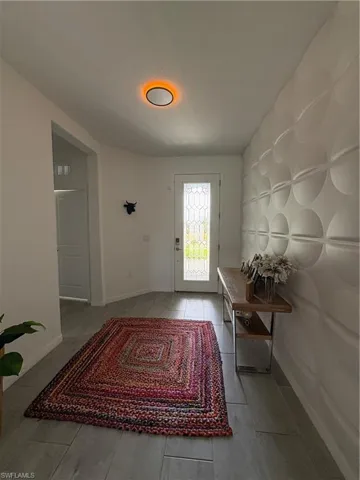 Doorway featuring baseboards