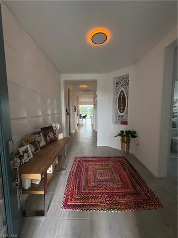 Corridor with baseboards and wood finish floors