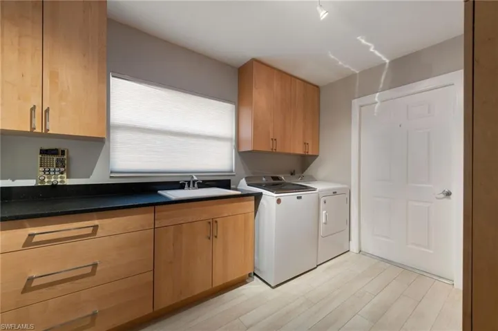 Indoor laundry room with cabinets