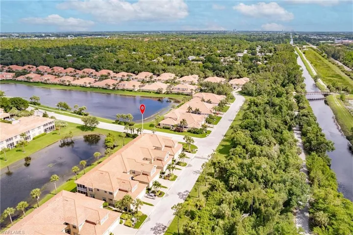 Birds eye view of property with a water view
