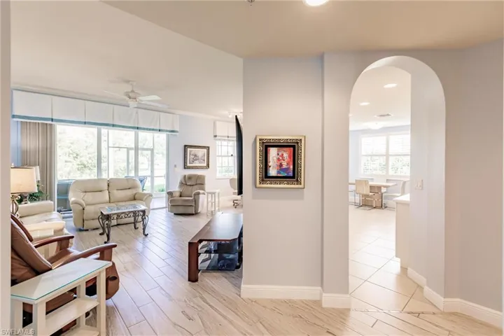 Living room with ceiling fan and light hardwood / wood-style flooring