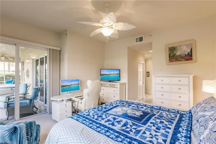 Bedroom with access to exterior, ceiling fan, and light colored carpet