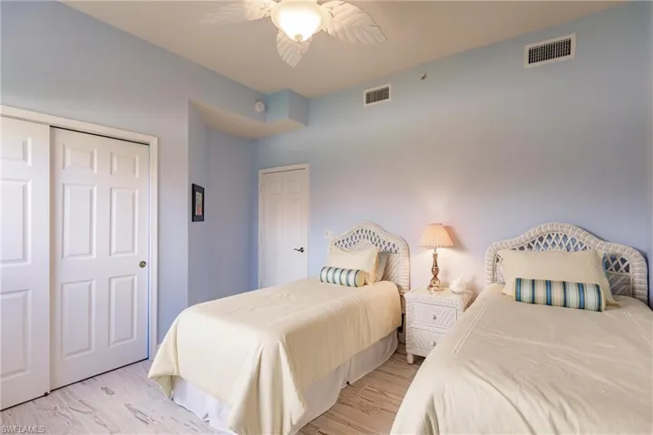 Bedroom featuring a closet, ceiling fan, and light hardwood / wood-style flooring