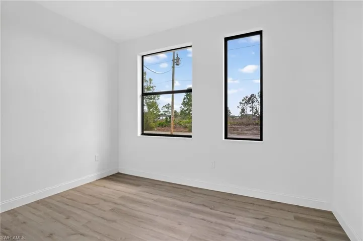 Empty room with light wood finished floors and baseboards