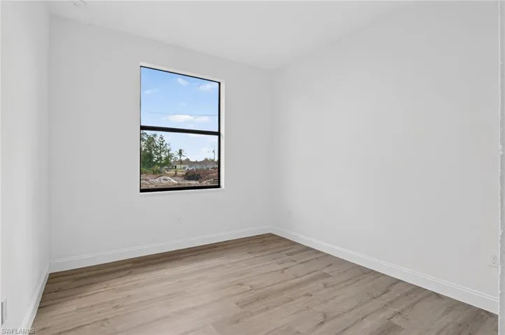 Empty room featuring light wood-type flooring and baseboards