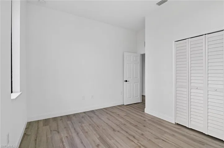 Unfurnished bedroom featuring light wood finished floors and a closet