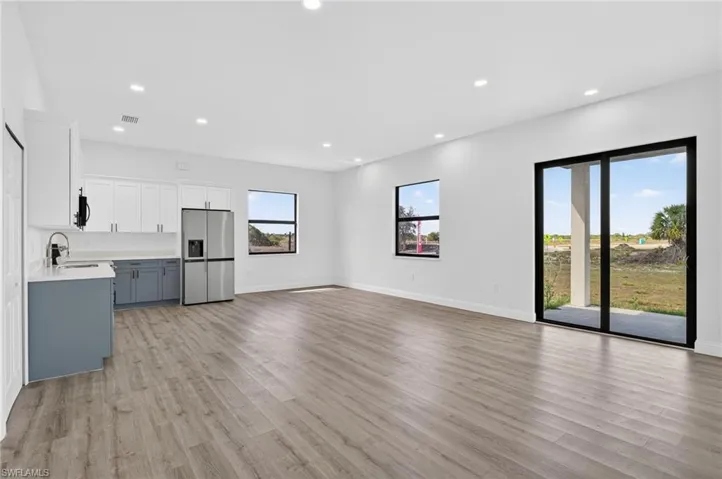 Unfurnished living room featuring light wood-style flooring and recessed lighting
