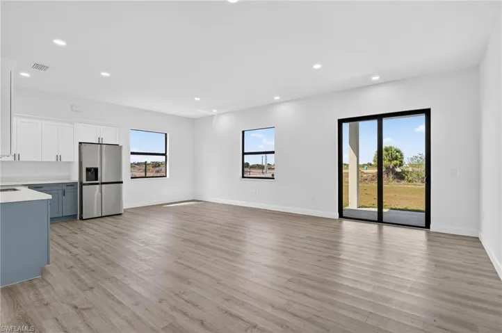 Unfurnished living room with recessed lighting and light wood finished floors