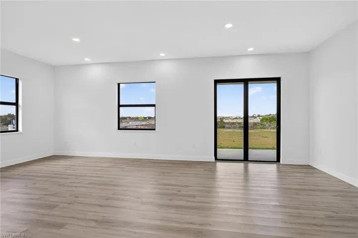 Empty room featuring recessed lighting, healthy amount of natural light, and light wood finished floors