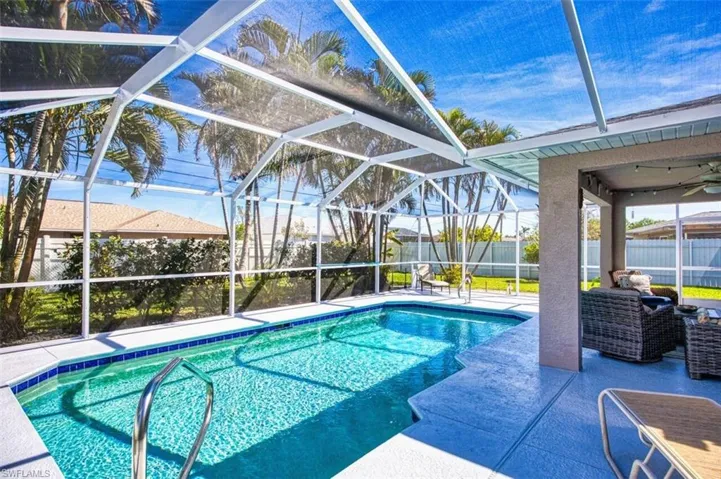 View of swimming pool with a fenced backyard, a lanai, and a patio