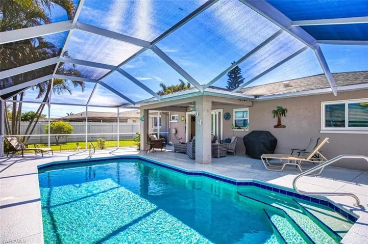 View of swimming pool with a patio area, a fenced in pool, area for grilling, fence, and an outdoor hangout area