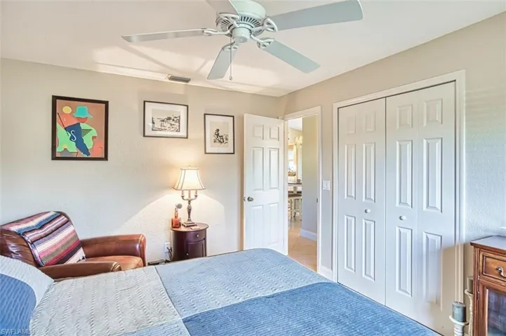 Bedroom with a closet, ceiling fan, and visible vents