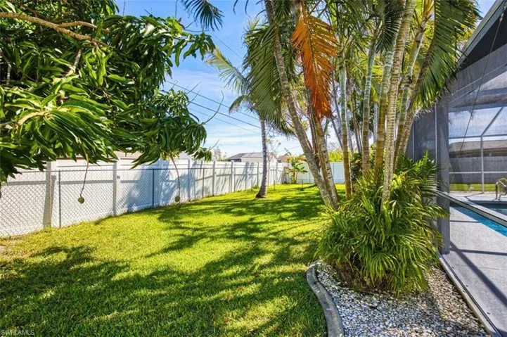 View of yard featuring a fenced backyard, a lanai, and a fenced in pool