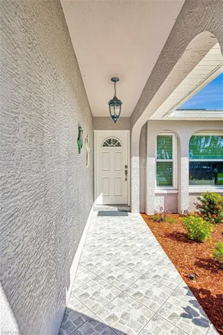 Doorway to property featuring stucco siding