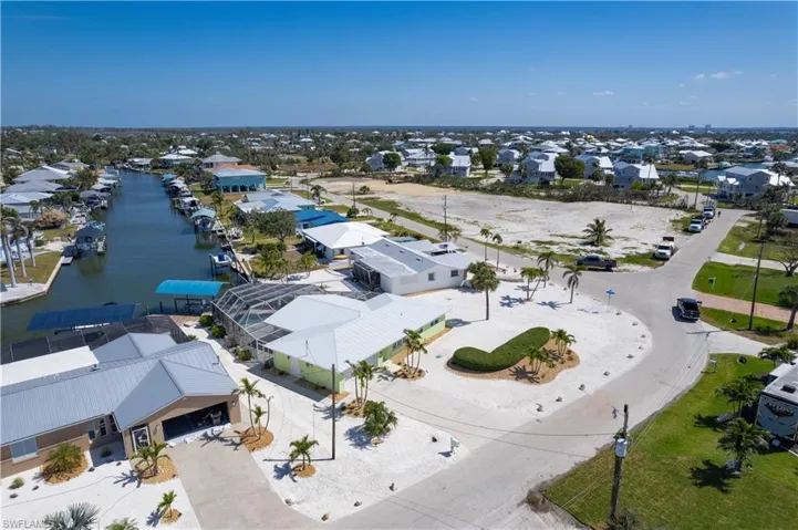 Aerial view featuring a water view and a residential view of the large lot