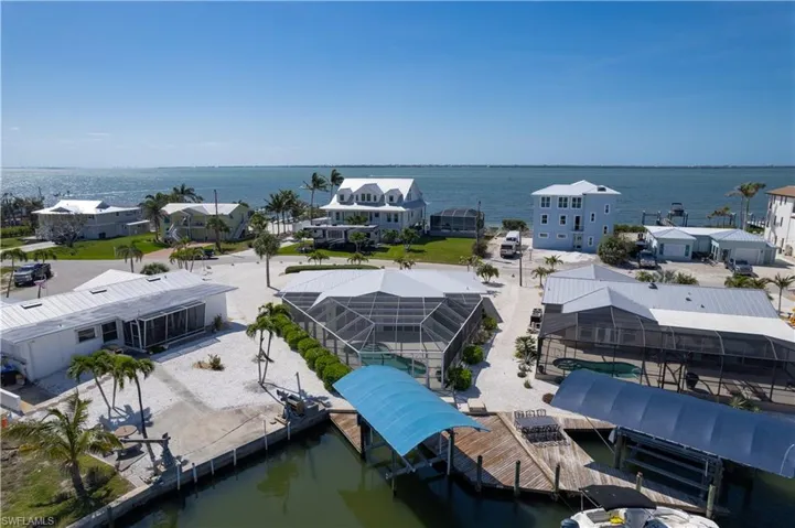 Drone / aerial view with a water view of the bay with Sanibel in the distance.