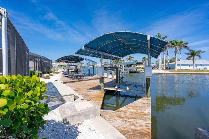 Dock area with a water view and covered boat lift