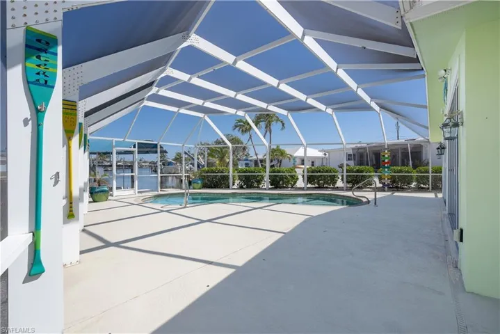 Outdoor pool with a patio area and screen enclosure