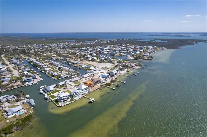 Birds eye view of property featuring a water view of the access canal to the residence.