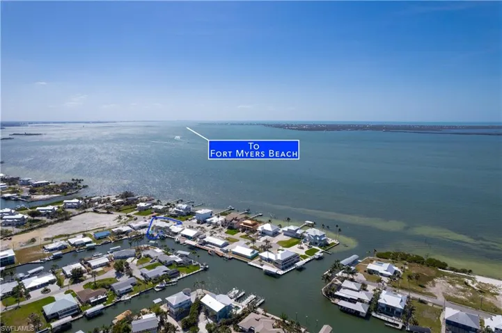Drone / aerial view featuring a residential view and a water view of the Southern part of Pine Island and Sanibel across the bay and Fort Myers Beach to the South East