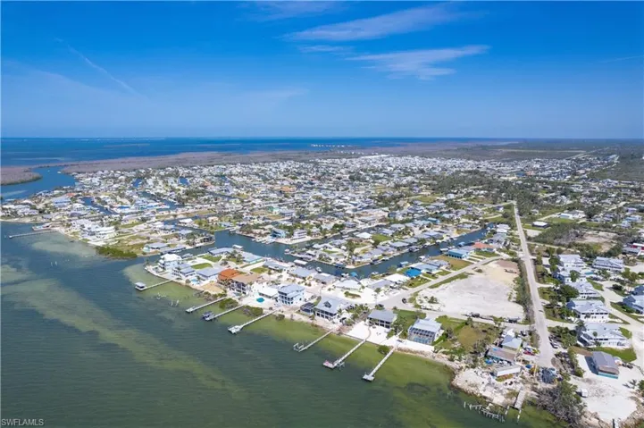 Birds eye view of property with a residential view of the Southern tip of Pine Island and a water view of the bay