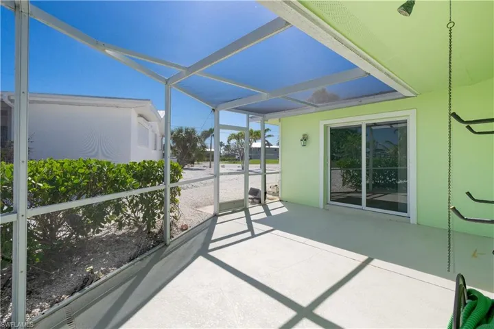 View of  sunroom with outdoor shower.